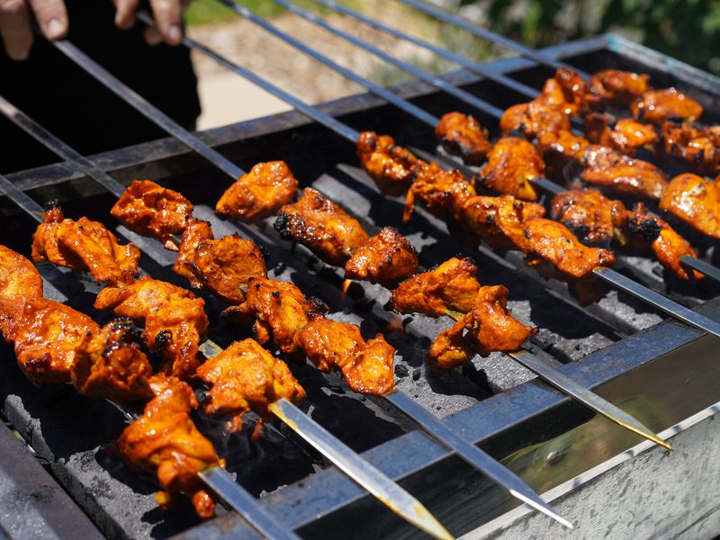Spice-marinated chicken skewers on the grill