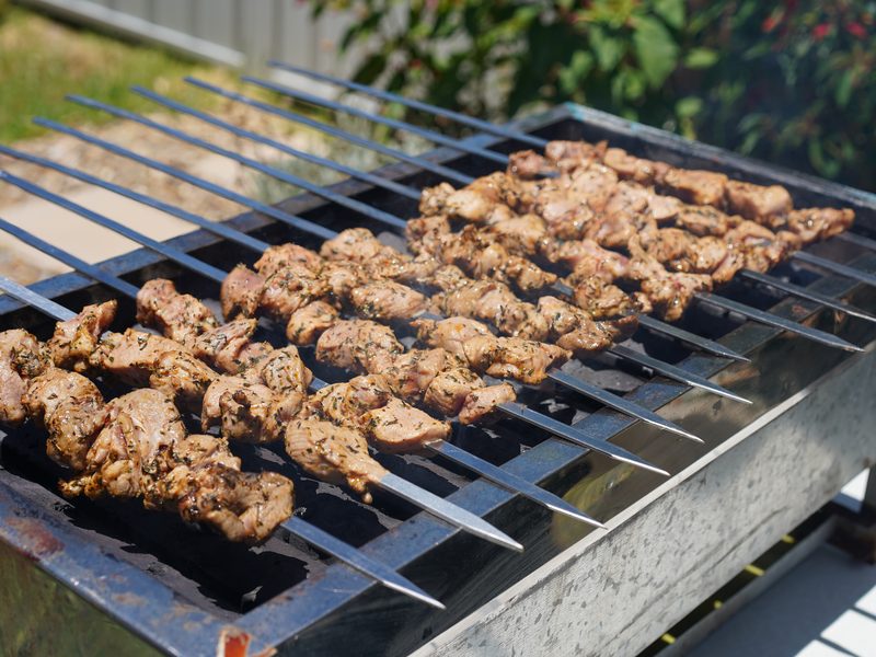 Herb-marinated pork skewers on the charcoal grill